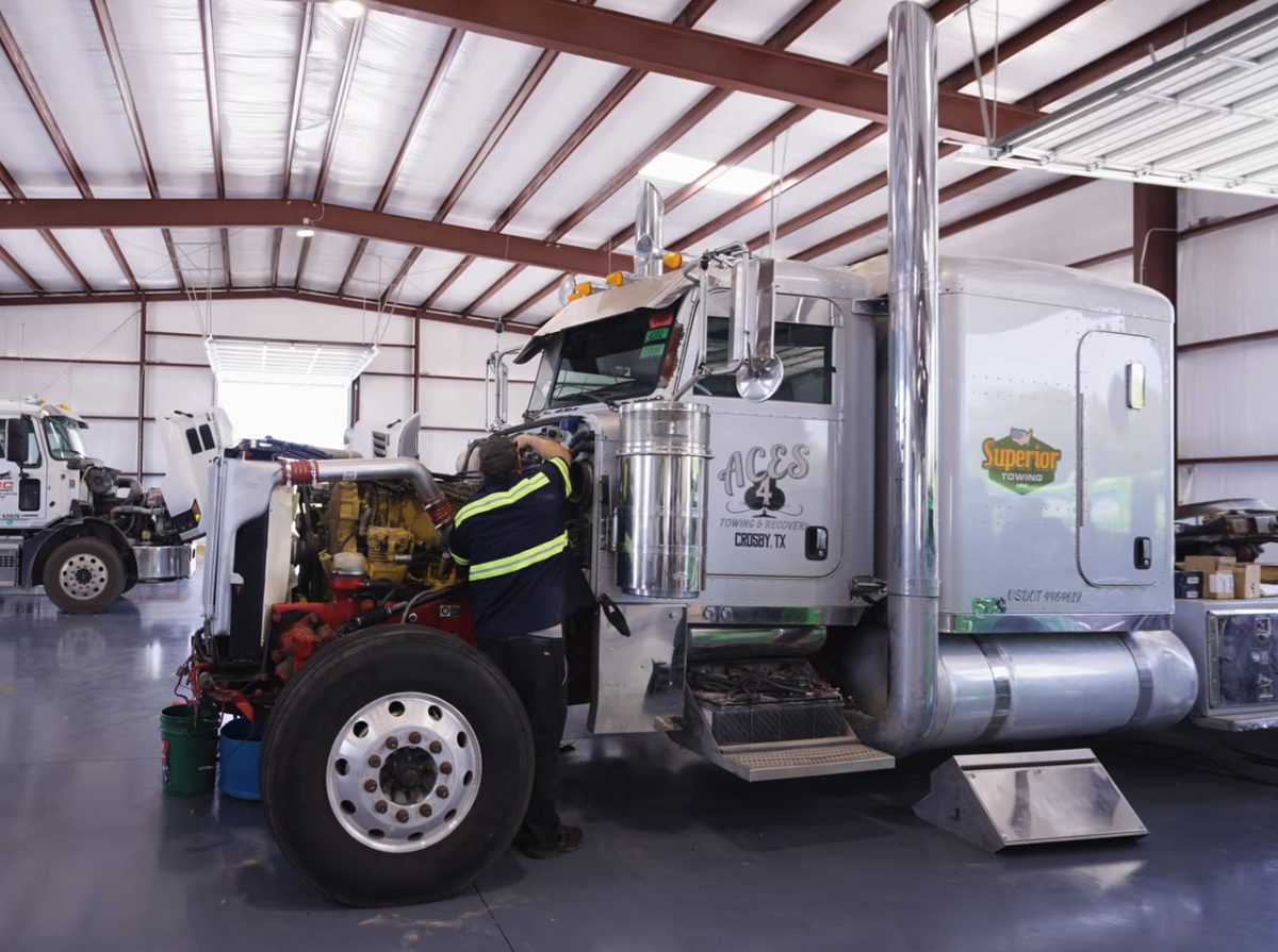A Delta Truck Center technician working on a truck in the shop