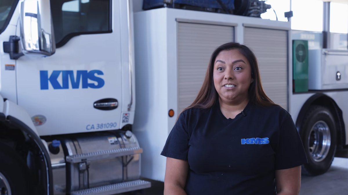 A member of the KMS Mechanics team in front of a service truck