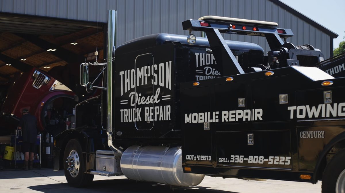 A Thompson Diesel Truck Repair mobile repair and towing truck outside the shop
